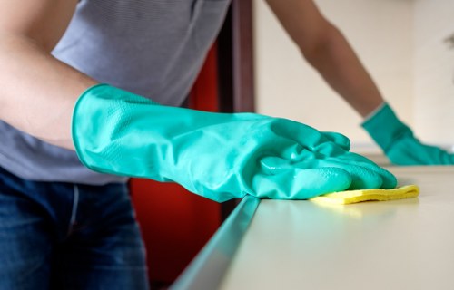 Local cleaner treating stubborn stains on a fabric sofa